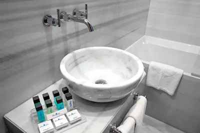 a bathroom with a white sink and a bath tub at Celine Hotel - Ottoman Mansion in Istanbul