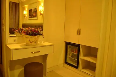 a room with a table with a vase of flowers on it at Mekke Hotel Istanbul in Istanbul