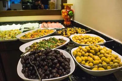 a buffet of different types of food on a counter at Mekke Hotel Istanbul in Istanbul