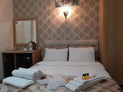 a bedroom with a bed with towels on it at Burak Apart in Istanbul
