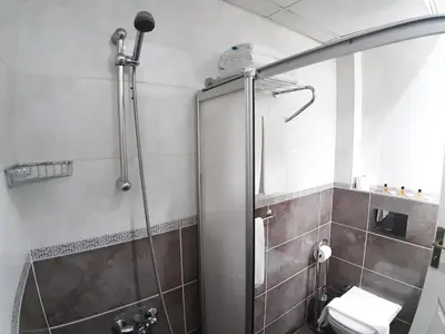 a bathroom with a shower and a toilet at Burak Apart in Istanbul