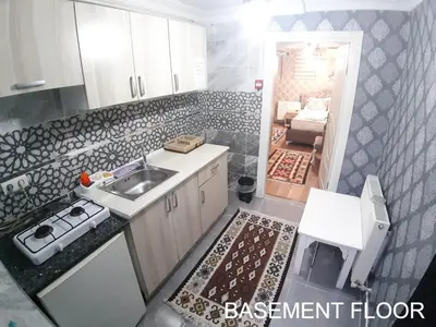 a small kitchen with a sink and a stove at Burak Apart in Istanbul