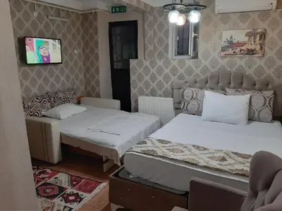 a bedroom with two beds and a couch at Burak Apart in Istanbul