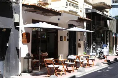 a group of tables and chairs with umbrellas outside a building at New Pera in Istanbul