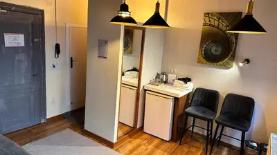 a small kitchen with a mirror and two chairs at New Pera in Istanbul