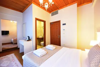 a bedroom with a bed and a bathroom at Elyka Hotel in Istanbul