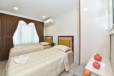 two beds in a hotel room with two strawberries on them at Sea Moon Hotel in Istanbul