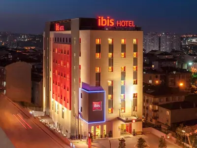 a hotel building with a sign on top of it at Ibis Istanbul Esenyurt in Istanbul