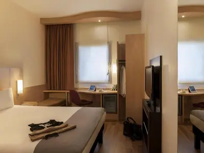 a hotel room with a bed and a television at Ibis Istanbul Esenyurt in Istanbul