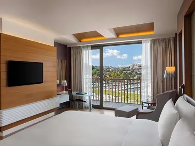 a hotel room with a bed and a television at The Grand Tarabya Managed by Accor in Istanbul