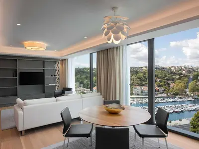 a living room with a couch and a table with chairs at The Grand Tarabya Managed by Accor in Istanbul