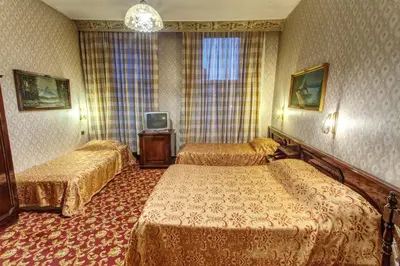 a hotel room with two beds and a television at Grand Hotel de Londres in Istanbul
