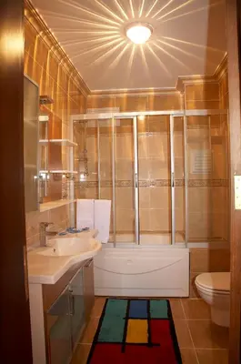 a bathroom with a sink and a tub and a toilet at Grand Hotel de Londres in Istanbul