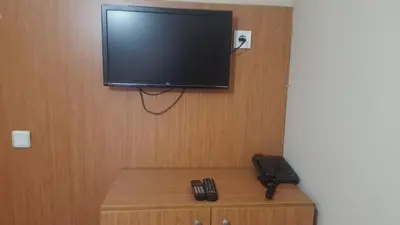 a flat screen tv hanging on a wall at Kadikoy Otel in Istanbul