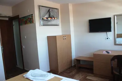 a hotel room with a bed and a tv on the wall at Kadikoy Otel in Istanbul