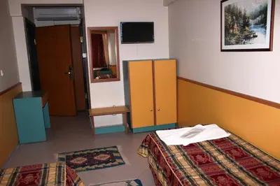 a hotel room with two beds and a tv at Kadikoy Otel in Istanbul