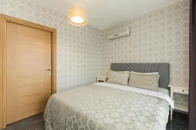 a bedroom with a bed with a white bedspread at The Loft House Taksim in Istanbul