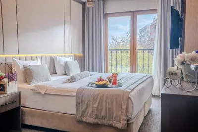 a bedroom with a bed with a tray of fruit on it at BEST GARDEN HOTEL in Istanbul