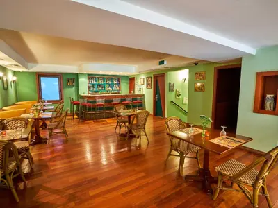 a restaurant with tables and chairs and green walls at Feronya Hotel in Istanbul