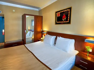 a hotel room with a bed and a mirror at Feronya Hotel in Istanbul