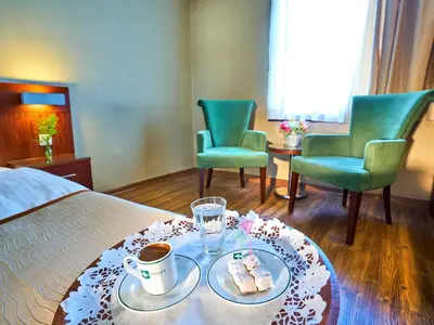a room with a bed with a tray of food and two chairs at Feronya Hotel in Istanbul