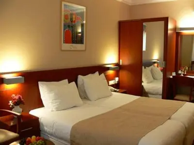 a hotel room with a large bed with white pillows at Feronya Hotel in Istanbul