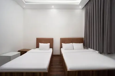 two twin beds in a room with curtains at Taksim Mood in Istanbul