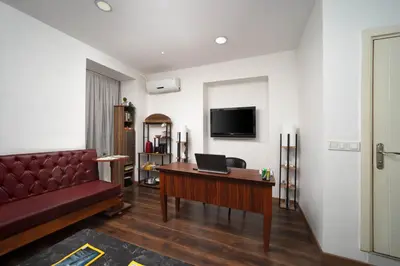 a living room with a couch and a desk with a laptop at Taksim Mood in Istanbul