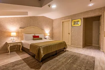 a bedroom with a large bed and a table at Eurostar Old City Hotel & Spa in Istanbul