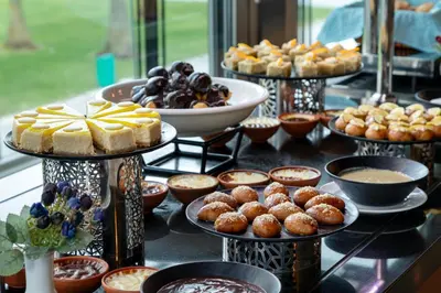 a table topped with different types of pastries and desserts at Miracle Istanbul Asia Airport Hotel & Spa in Istanbul