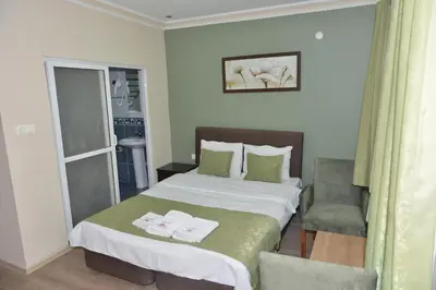 a hotel room with a bed and a chair at Teras Hotel Kağıthane in Istanbul