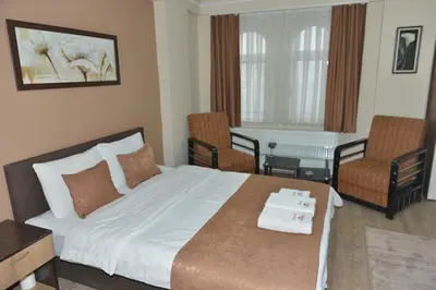 a hotel room with a bed and two chairs at Teras Hotel Kağıthane in Istanbul
