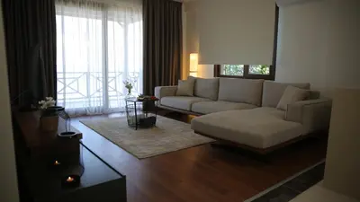 a living room with a couch and a large window at Orchid Hills - heated swimming pool in Sapanca