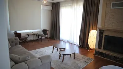 a living room with a couch and a fireplace at Orchid Hills - heated swimming pool in Sapanca