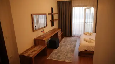 a hotel room with a bed and a mirror at Orchid Hills - heated swimming pool in Sapanca