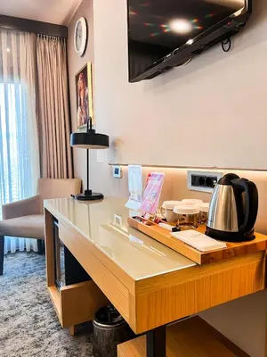 a hotel room with a desk with a tea kettle on it at Triada Hotel Karaköy in Istanbul