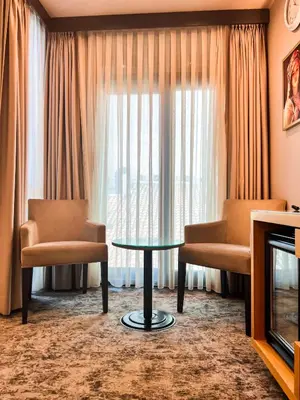 a room with two chairs and a table in front of a window at Triada Hotel Karaköy in Istanbul