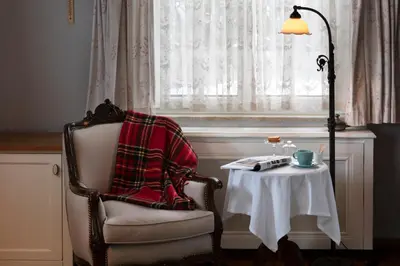 a chair with a blanket sitting next to a table at Casa Lavanda Boutique Hotel in Sile