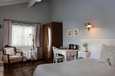 a bedroom with a bed and a desk and a table at Casa Lavanda Boutique Hotel in Sile