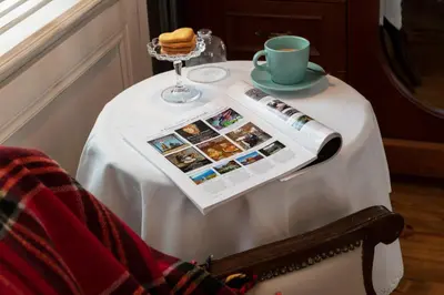 a table with a newspaper and a cup of coffee at Casa Lavanda Boutique Hotel in Sile