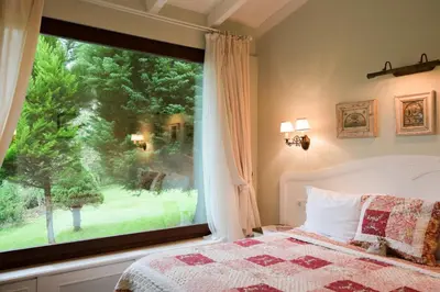 a bedroom with a bed and a large window at Casa Lavanda Boutique Hotel in Sile