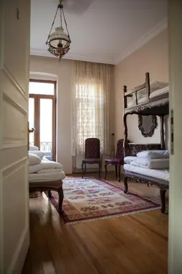 a bedroom with a canopy bed and two chairs at Chambers of the Boheme in Istanbul