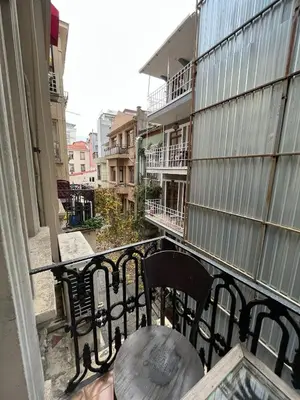 a balcony with a table and chairs on a building at Chambers of the Boheme in Istanbul