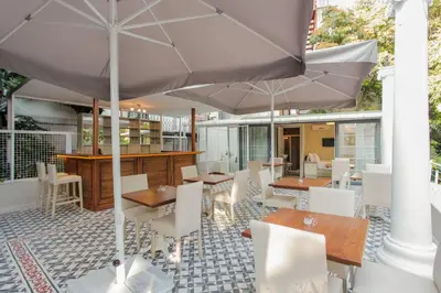 a restaurant with tables and chairs and umbrellas at The Loft Istanbul in Istanbul