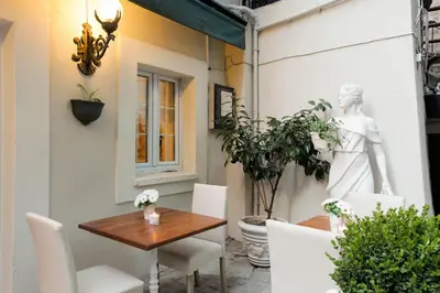 a patio with a table and chairs and a statue at The Loft Istanbul in Istanbul