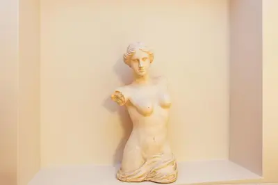 a statue of a woman sitting on a shelf at The Loft Istanbul in Istanbul