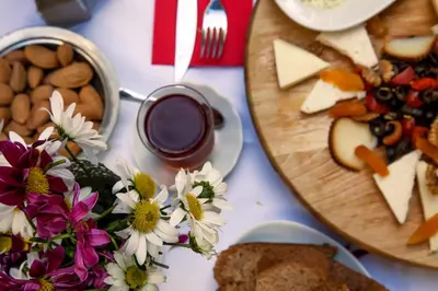 a table topped with plates of food and flowers at The Loft Istanbul in Istanbul