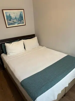 a bed in a small room with a white bedsheet at Elite Hotel City Center Corlu Bed and Breakfast in Corlu
