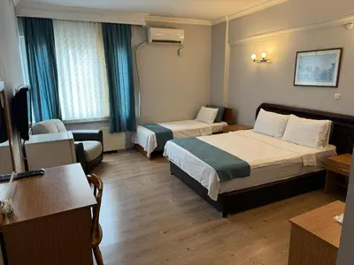 a hotel room with two beds and a television at Elite Hotel City Center Corlu Bed and Breakfast in Corlu