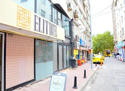 a city street with a building with a sign on it at Elite Hotel City Center Corlu Bed and Breakfast in Corlu
